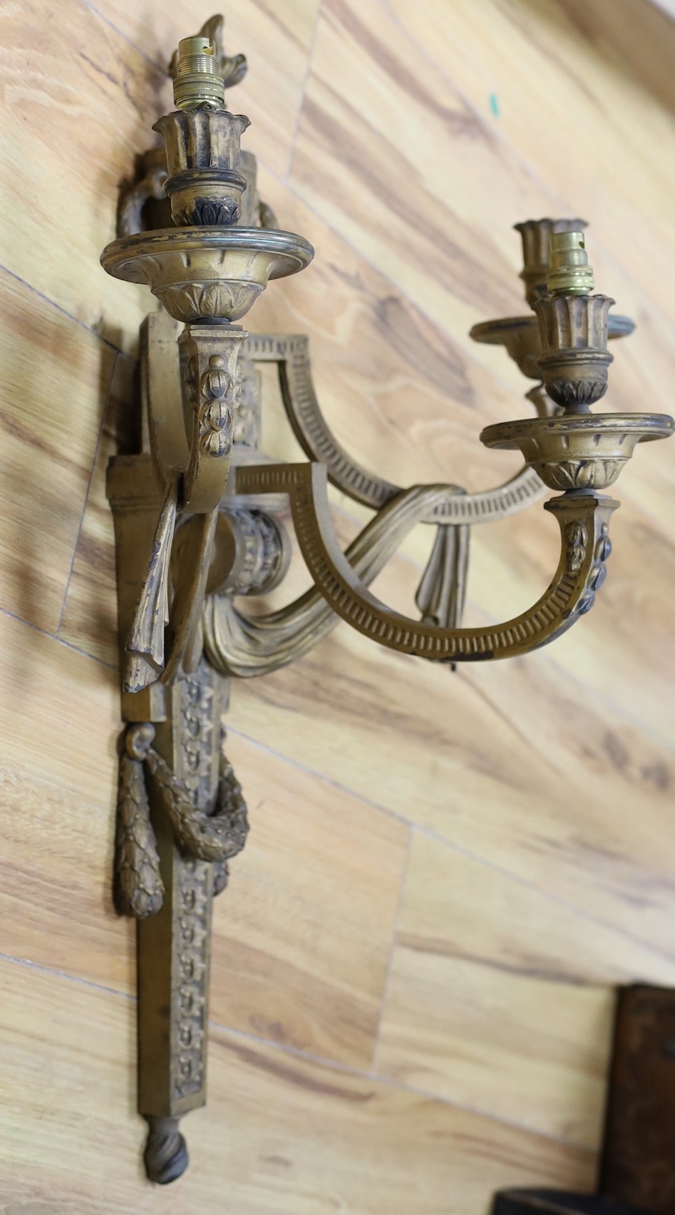 A contemporary bronze three branch wall sconce, 64cm